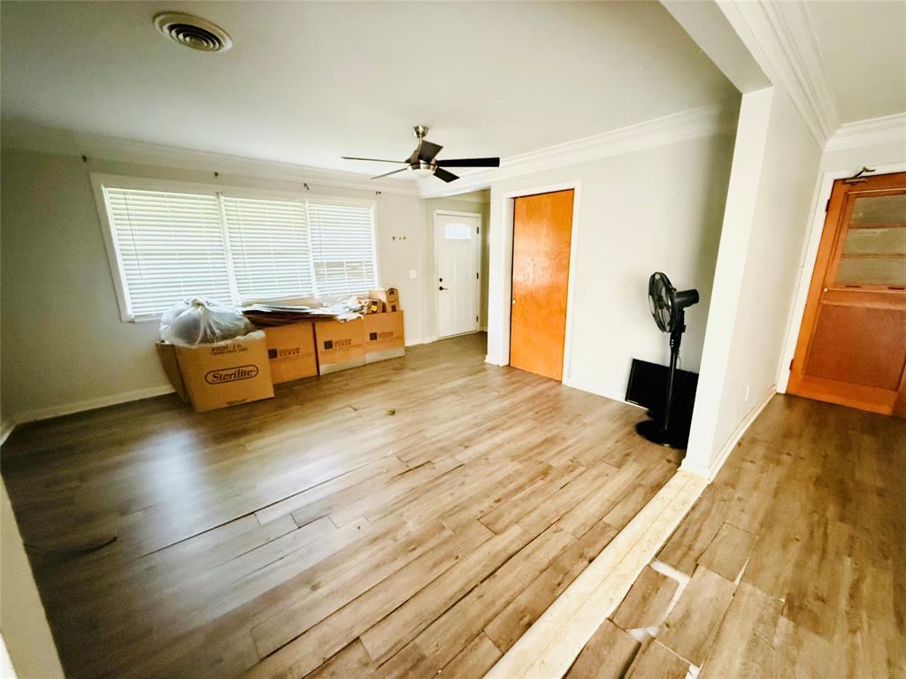 a bedroom with furniture and wooden floor