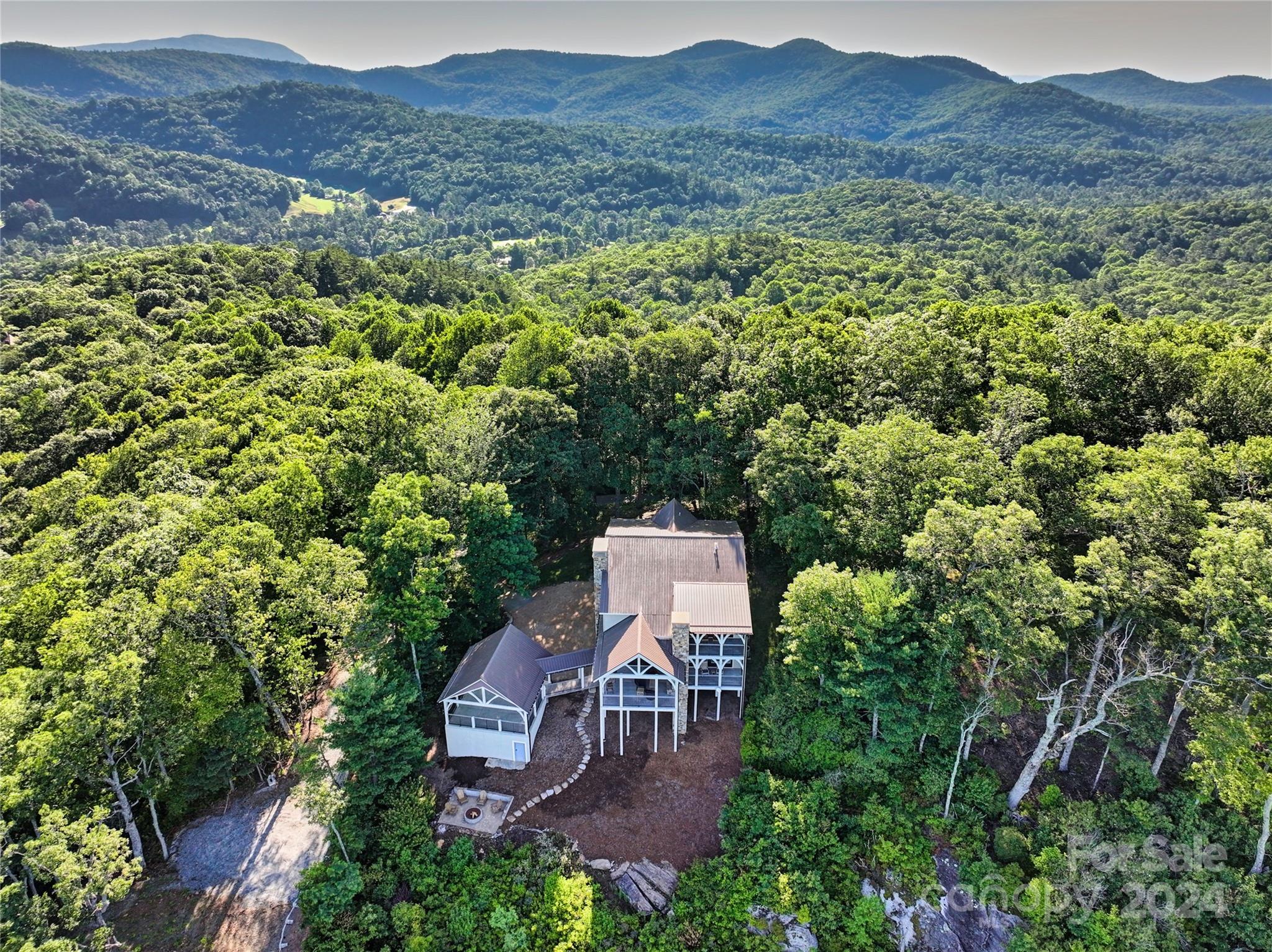 an aerial view of a house with mountain view