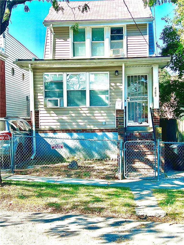 a view of a house with a yard and sitting area