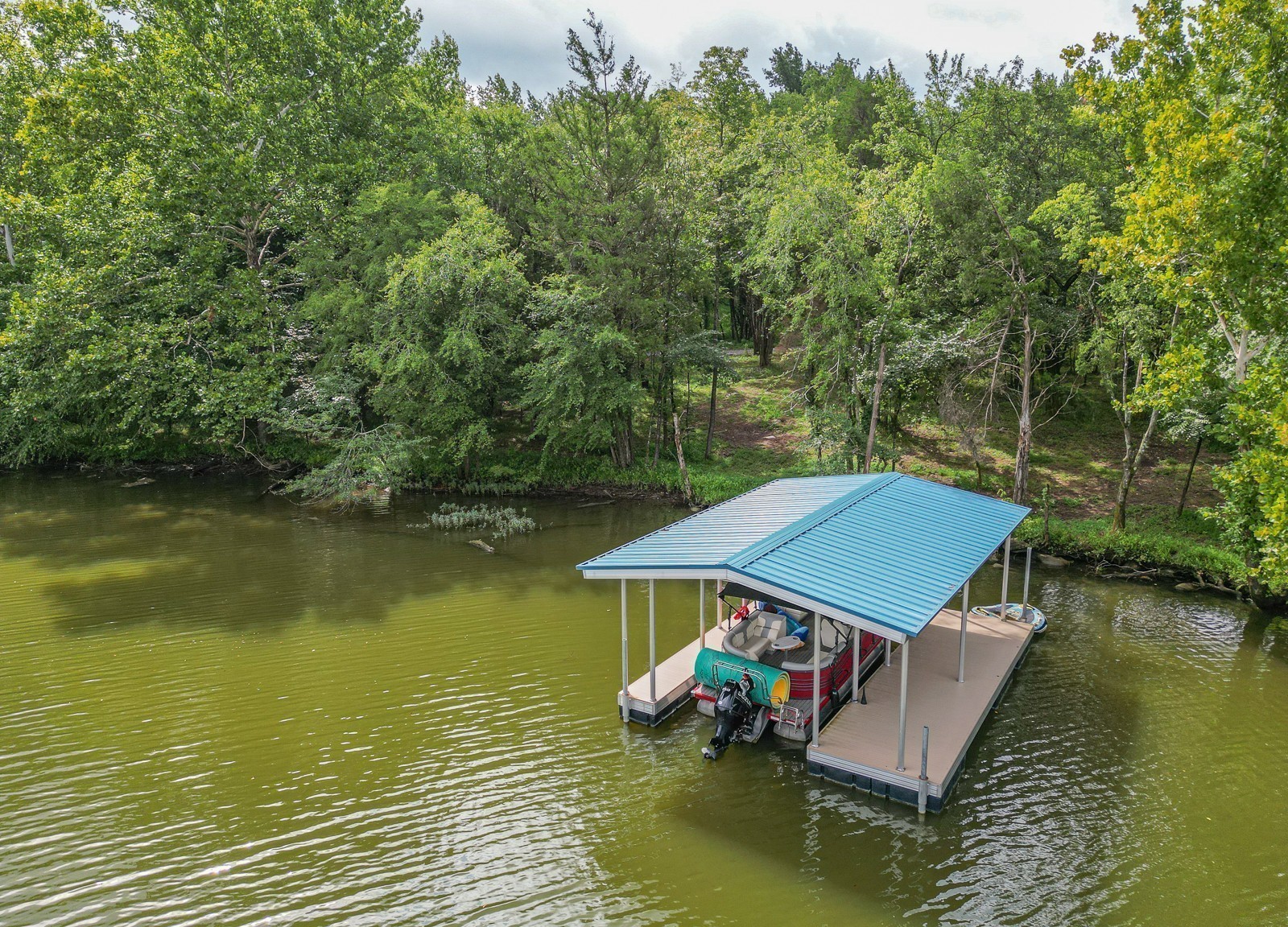 an aerial view of a house with swimming pool and lake view