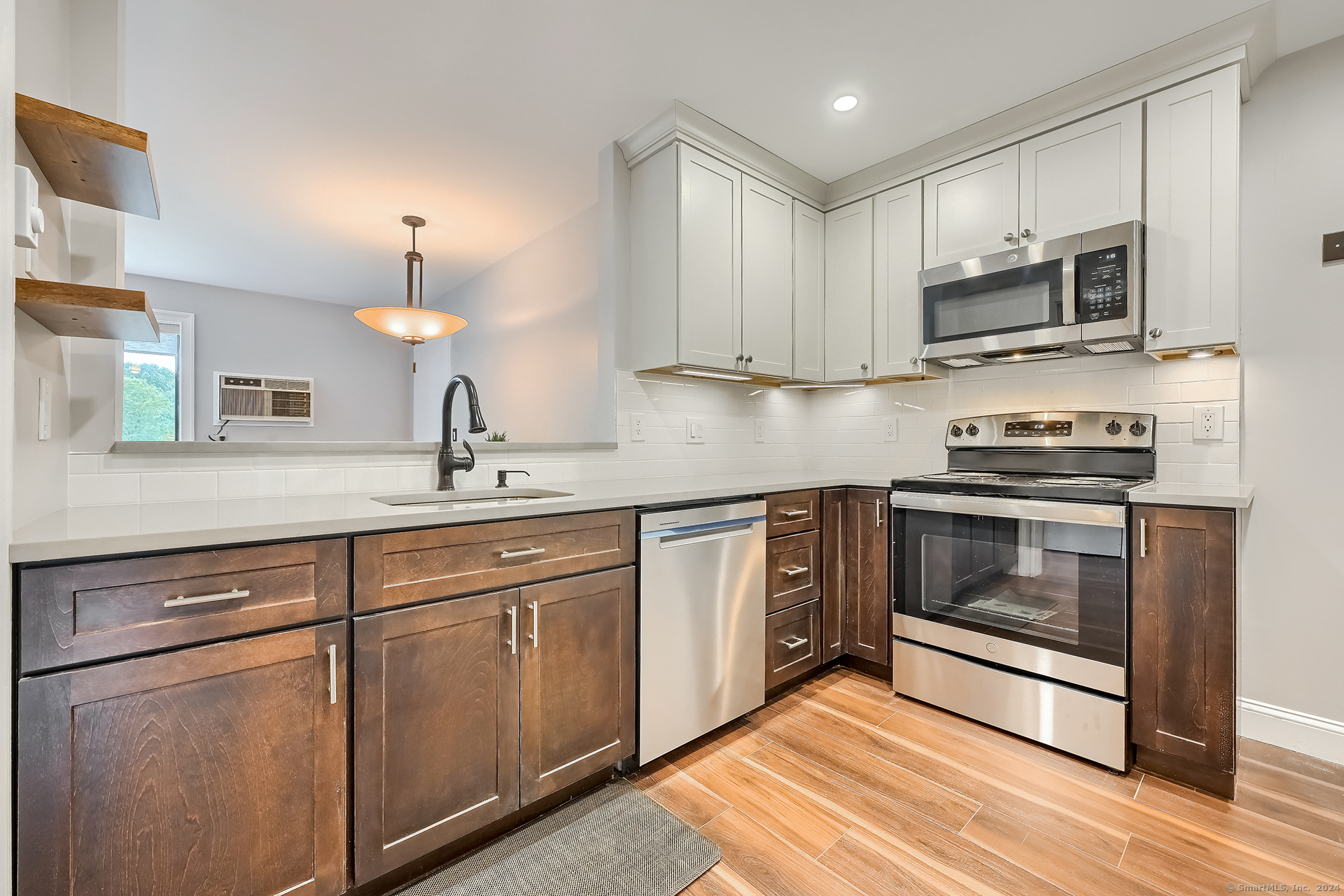 a kitchen with sink a microwave and cabinets