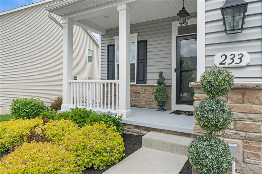 a view of a house with potted plants