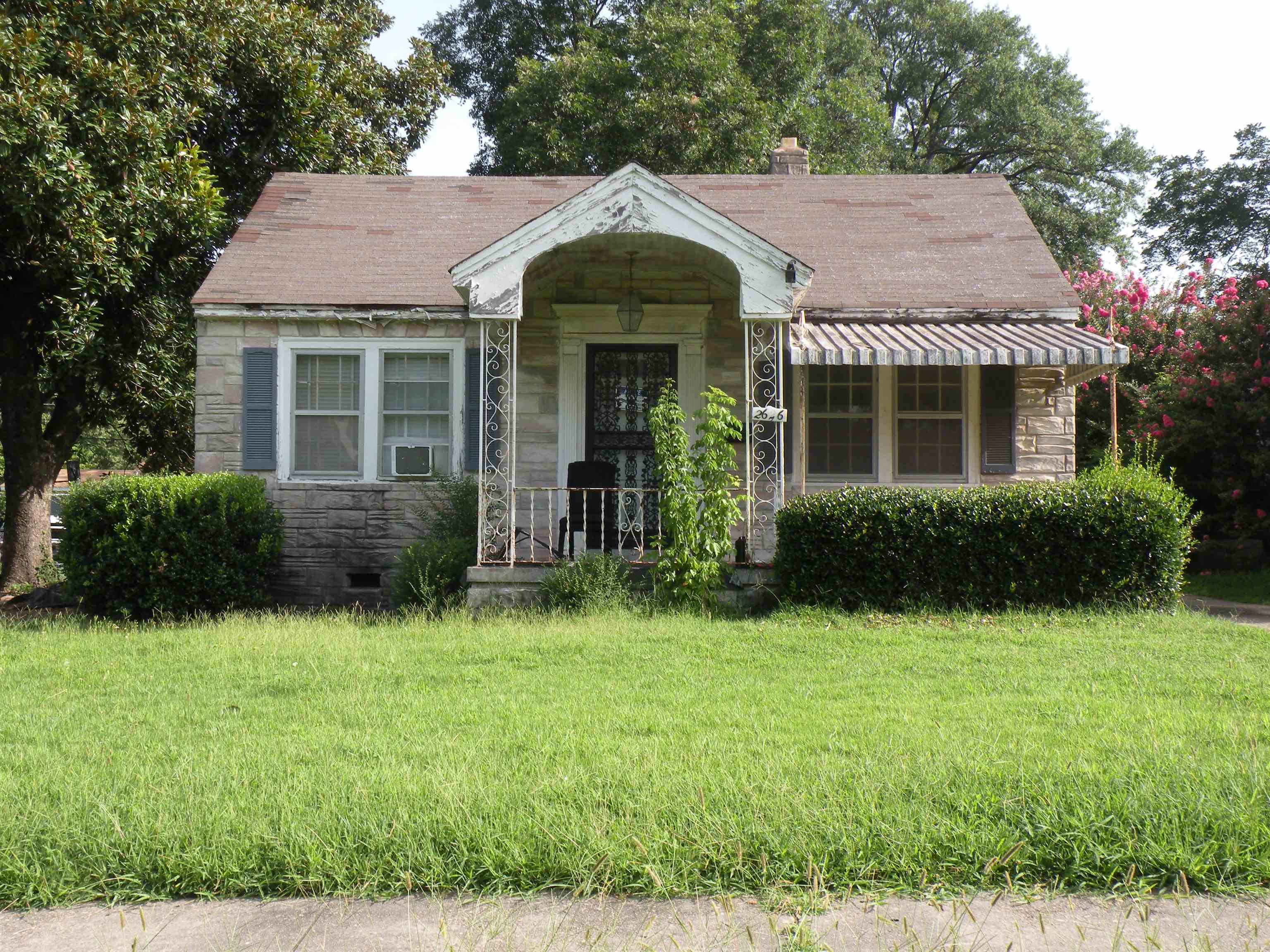 a front view of a house with garden