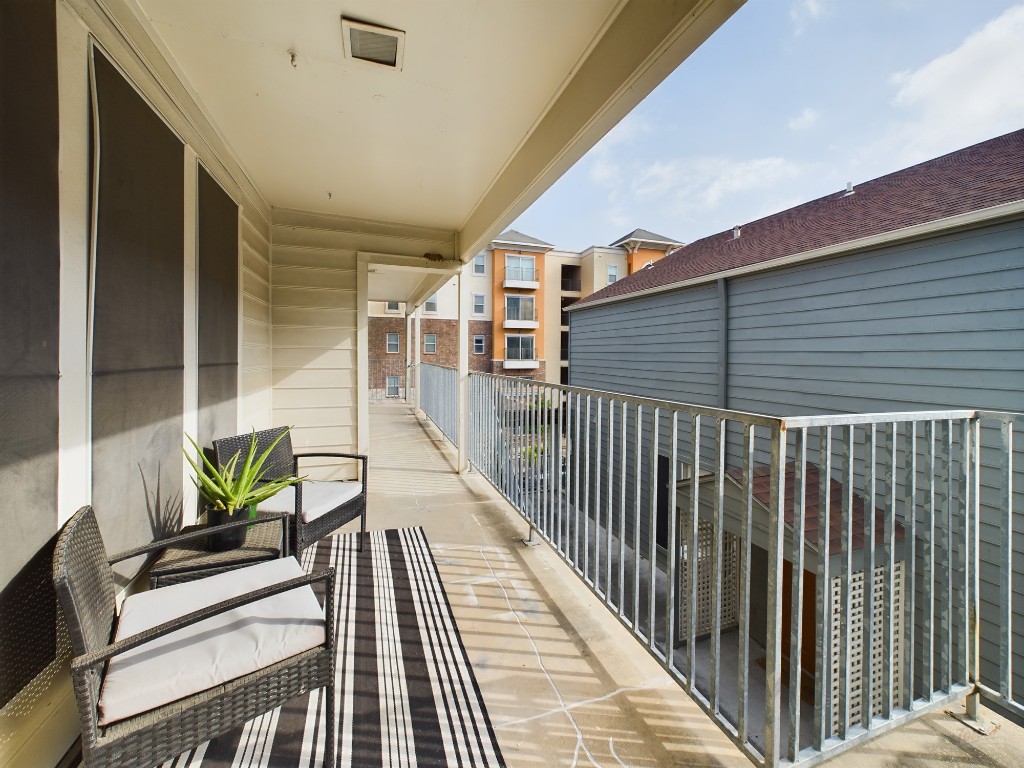 a view of balcony with furniture