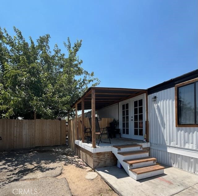 a view of house with backyard outdoor seating and wooden fence