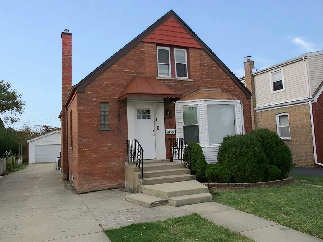 a front view of a house with a garden