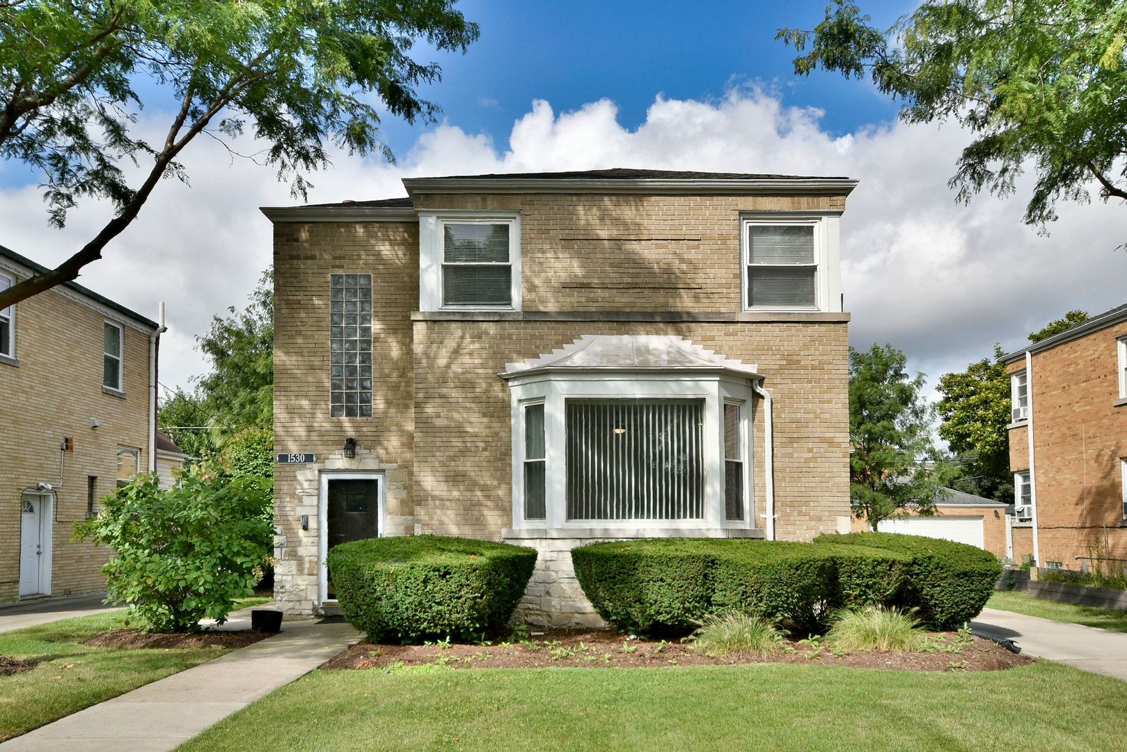 front view of a house with a garden