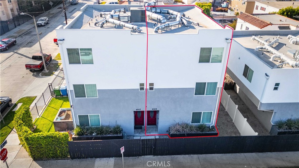 an aerial view of a house with a yard and potted plants