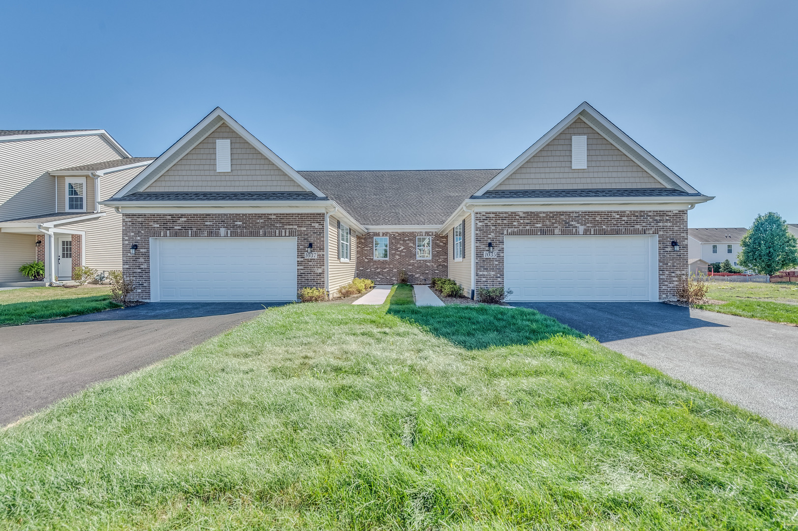 a front view of a house with a yard and garage