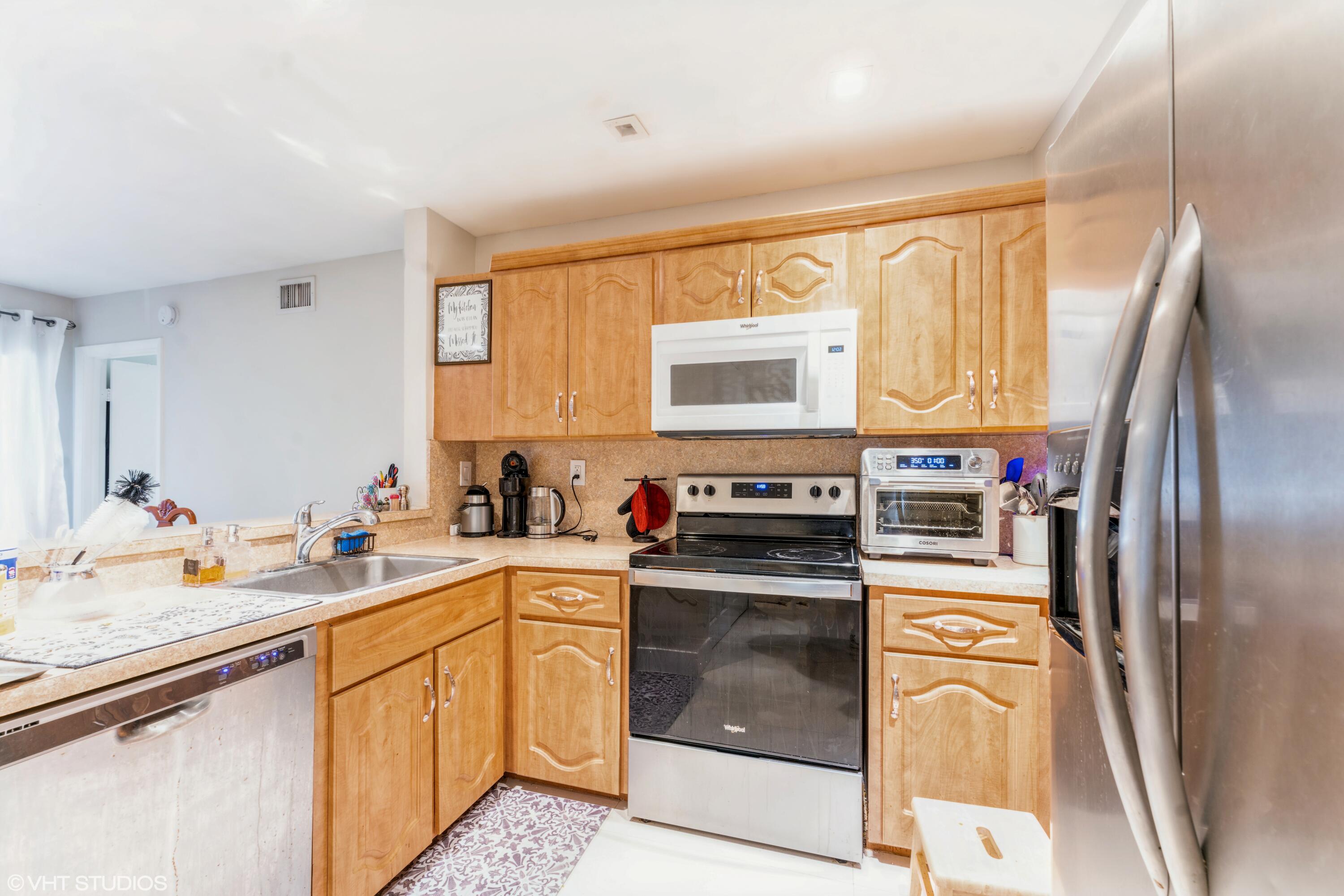 a kitchen with a sink stove and refrigerator