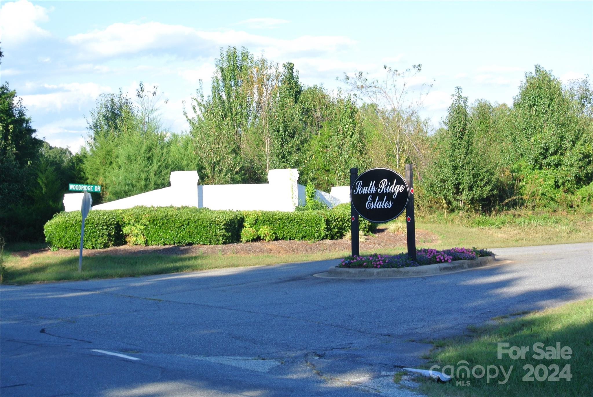 a sign board with view of lake in the back