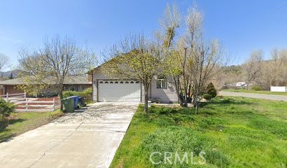 a view of a house with a yard and tree s