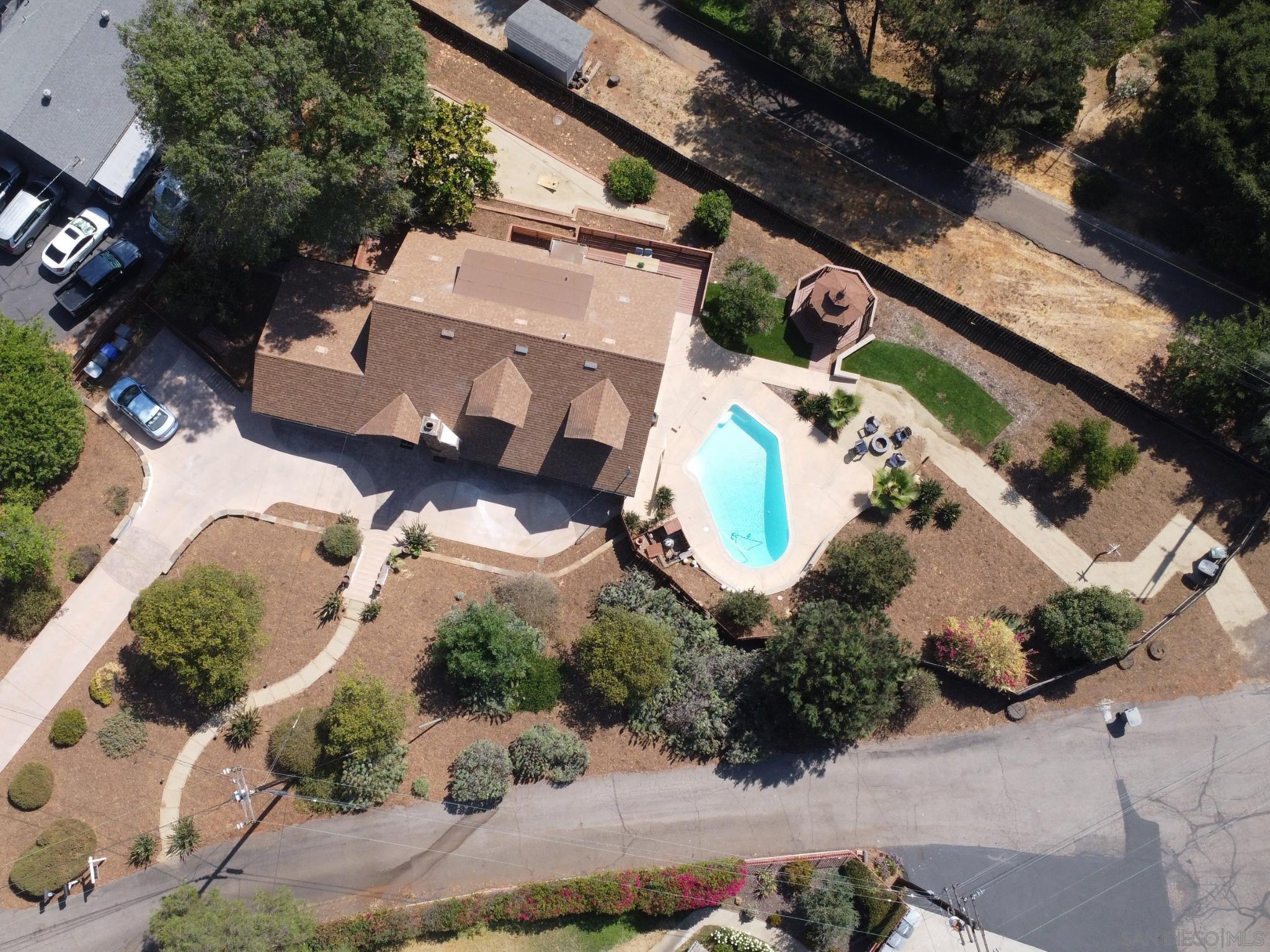 an aerial view of a house with a yard and lake