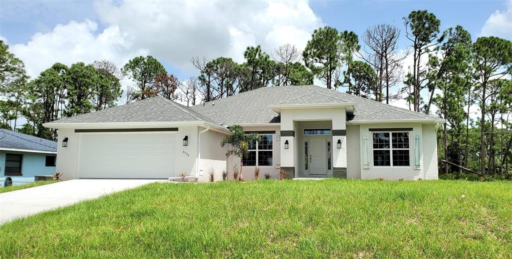 a view of a house with yard and tree s