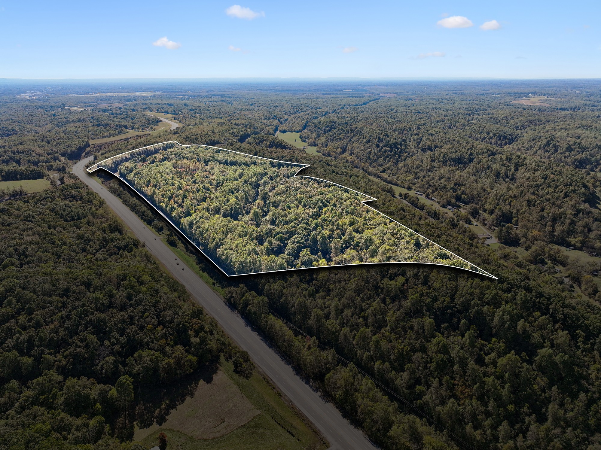 an aerial view of a houses with a yard