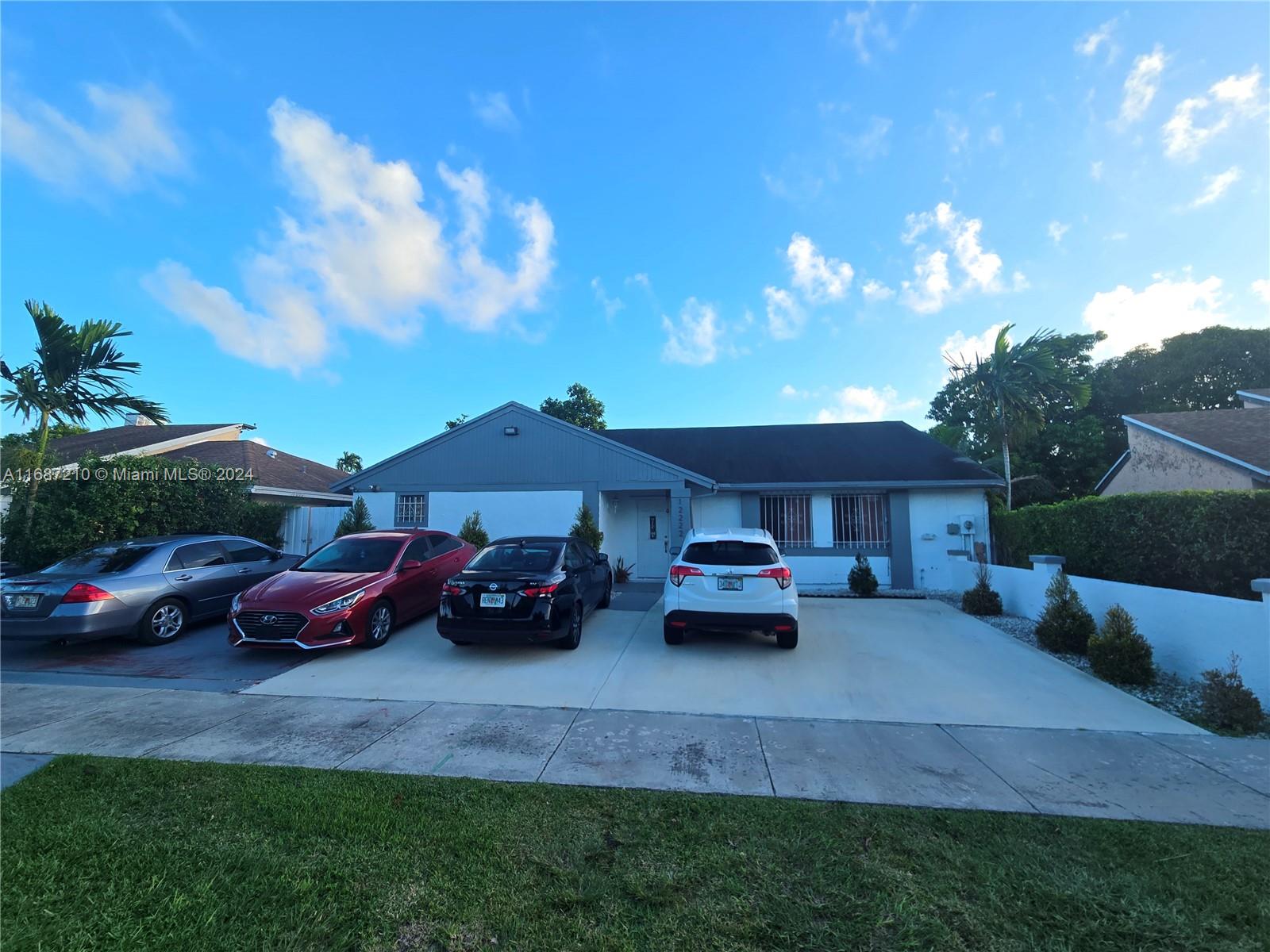 a couple of cars parked in front of a house