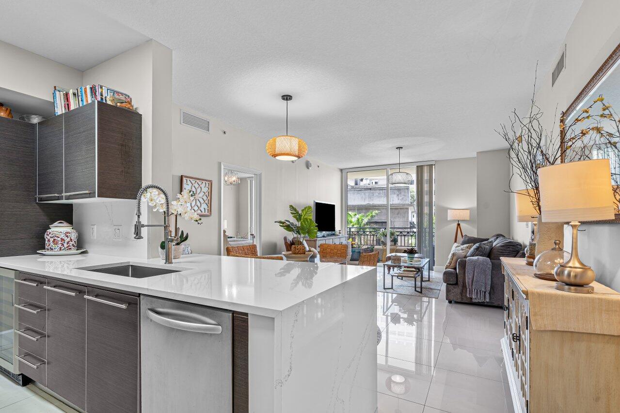 a kitchen with sink refrigerator and cabinets