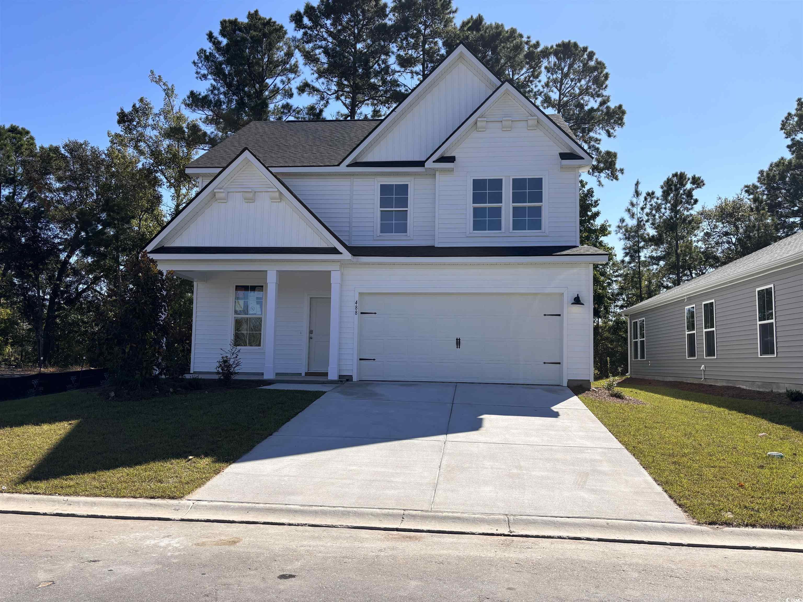 View of front of property featuring a front lawn a