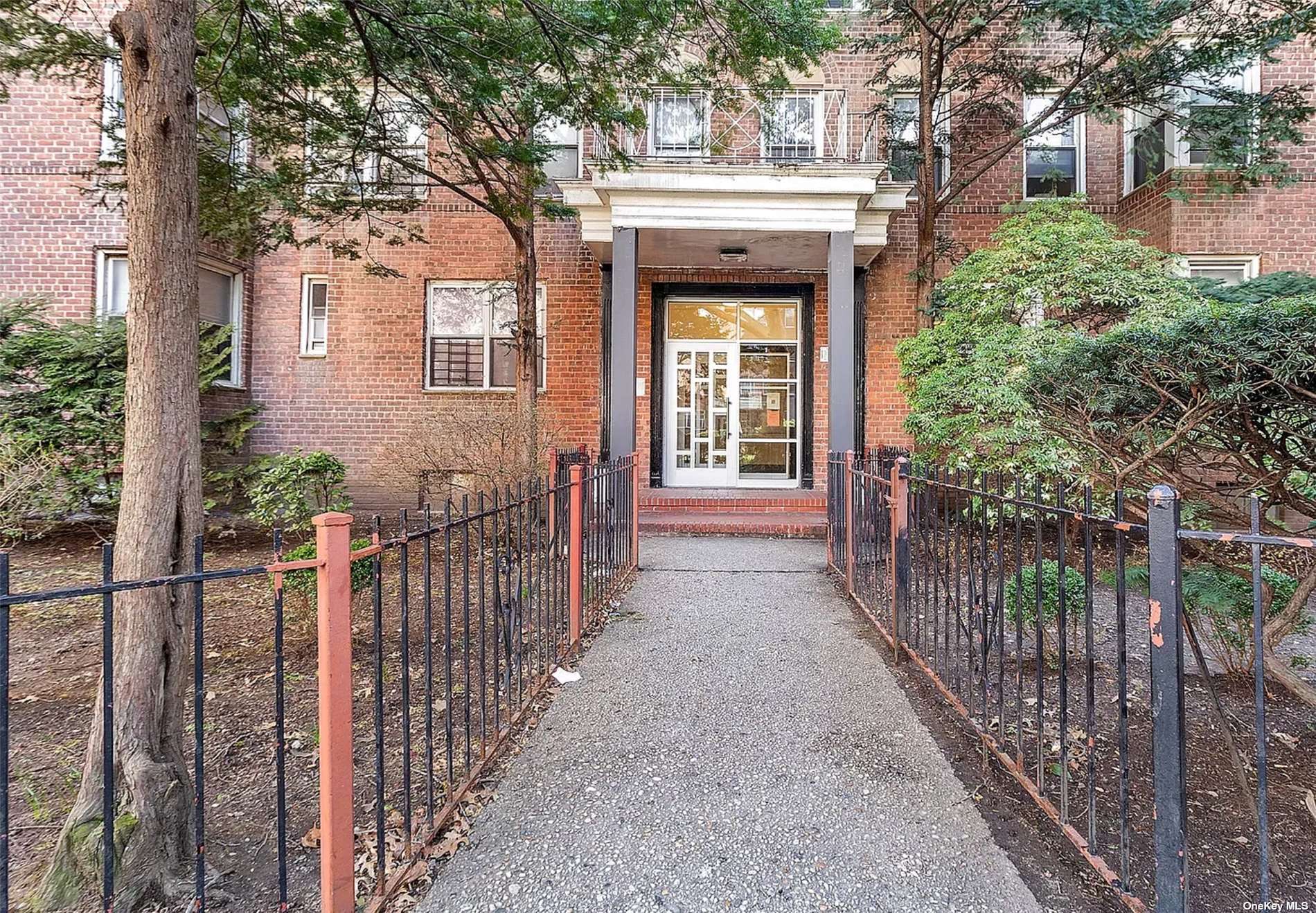 a view of entrance gate of house and tree