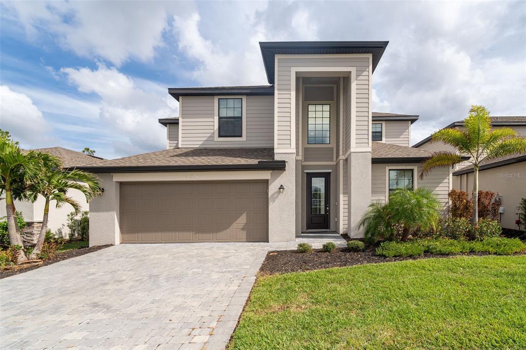 a front view of a house with a yard and garage