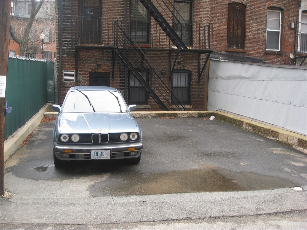 a car parked in parking lot of a house