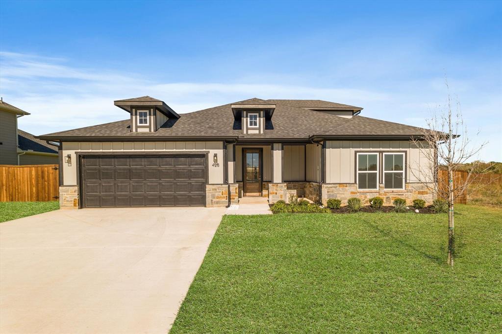 Prairie-style house with a front yard and a garage