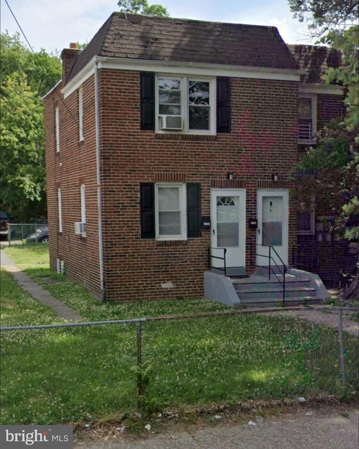 a front view of house with a garden