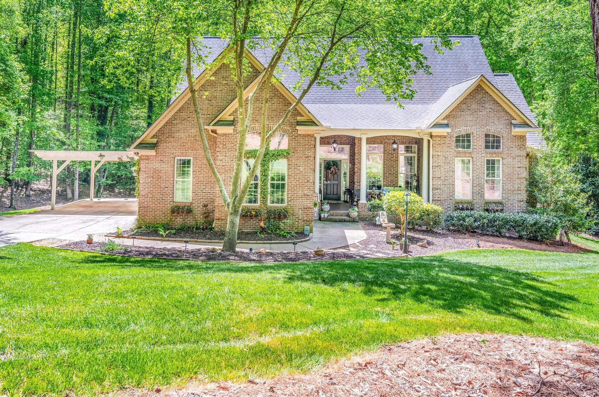 a view of a house with a yard and sitting area