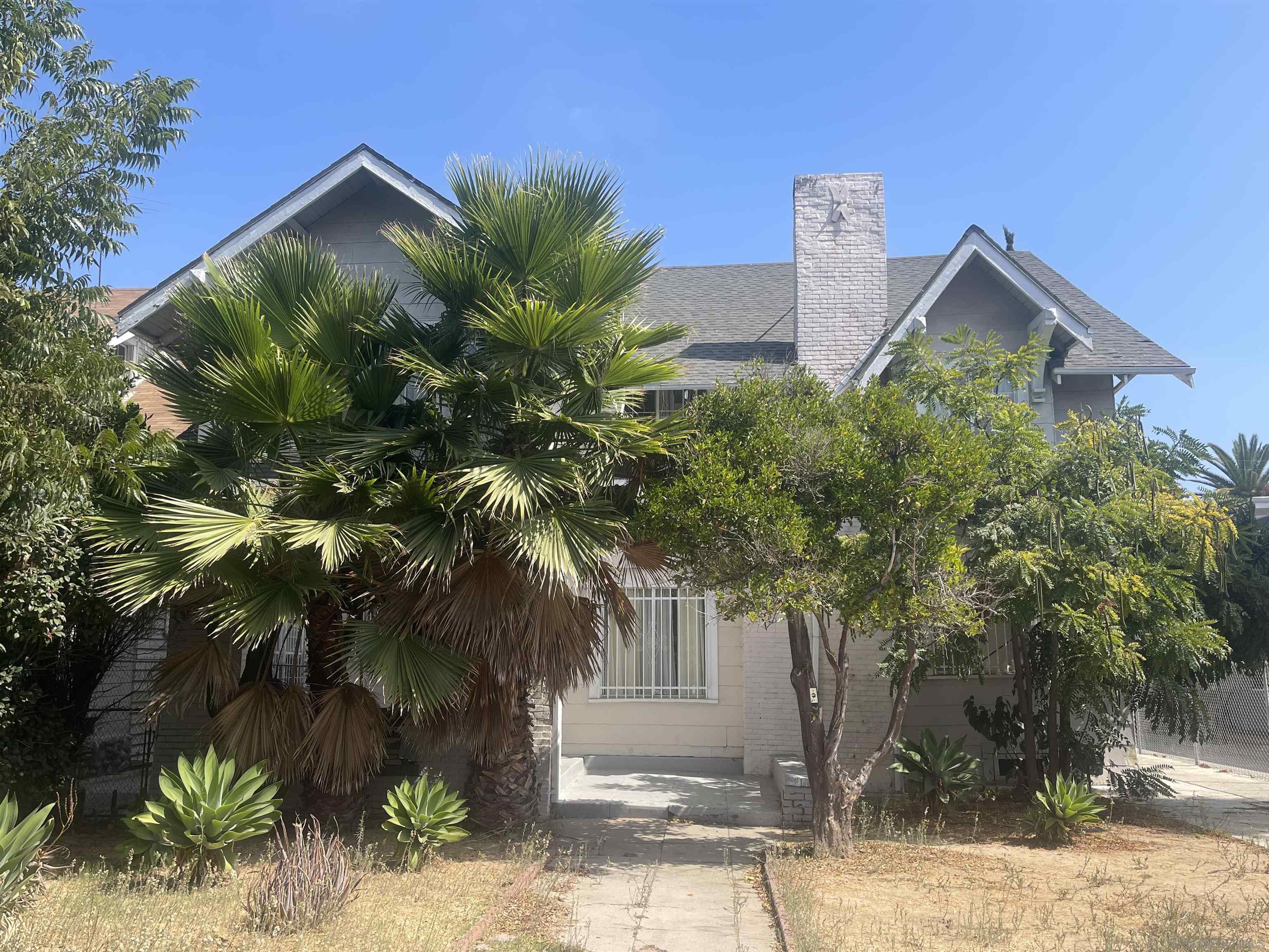 a view of a house with a tree and a yard