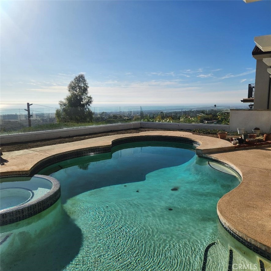 a view of a swimming pool and a yard