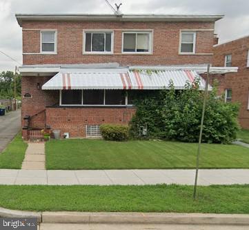 a front view of a house with a garden and garage