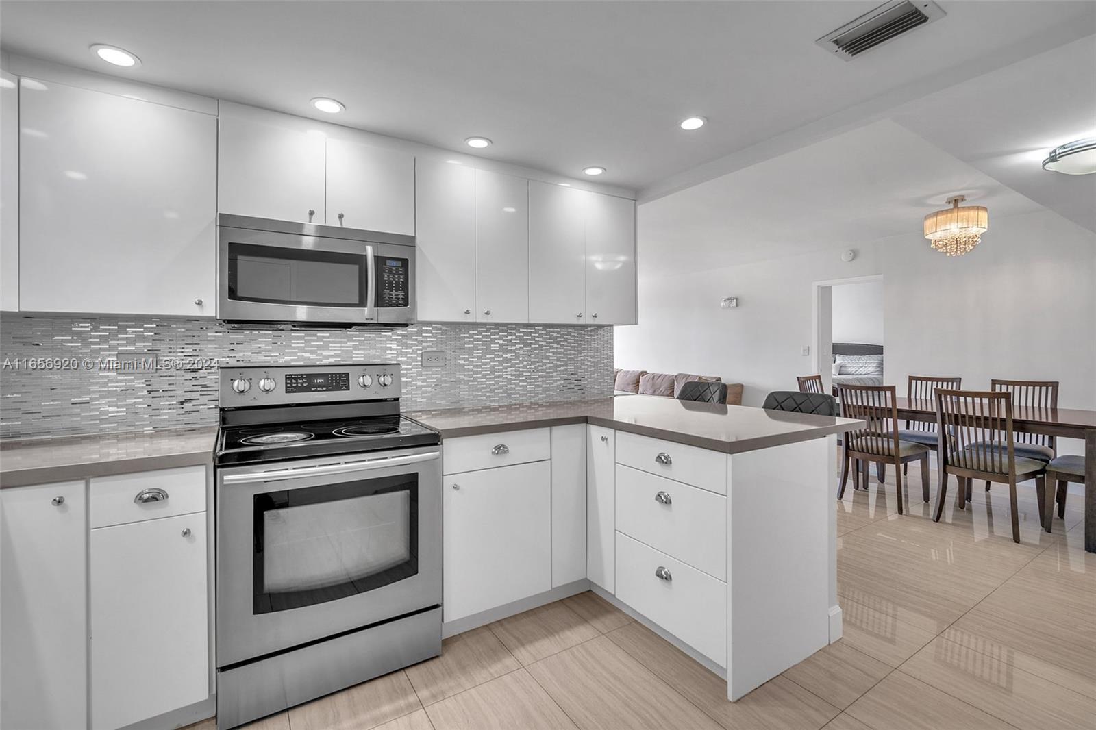 a kitchen with sink cabinets and stainless steel appliances