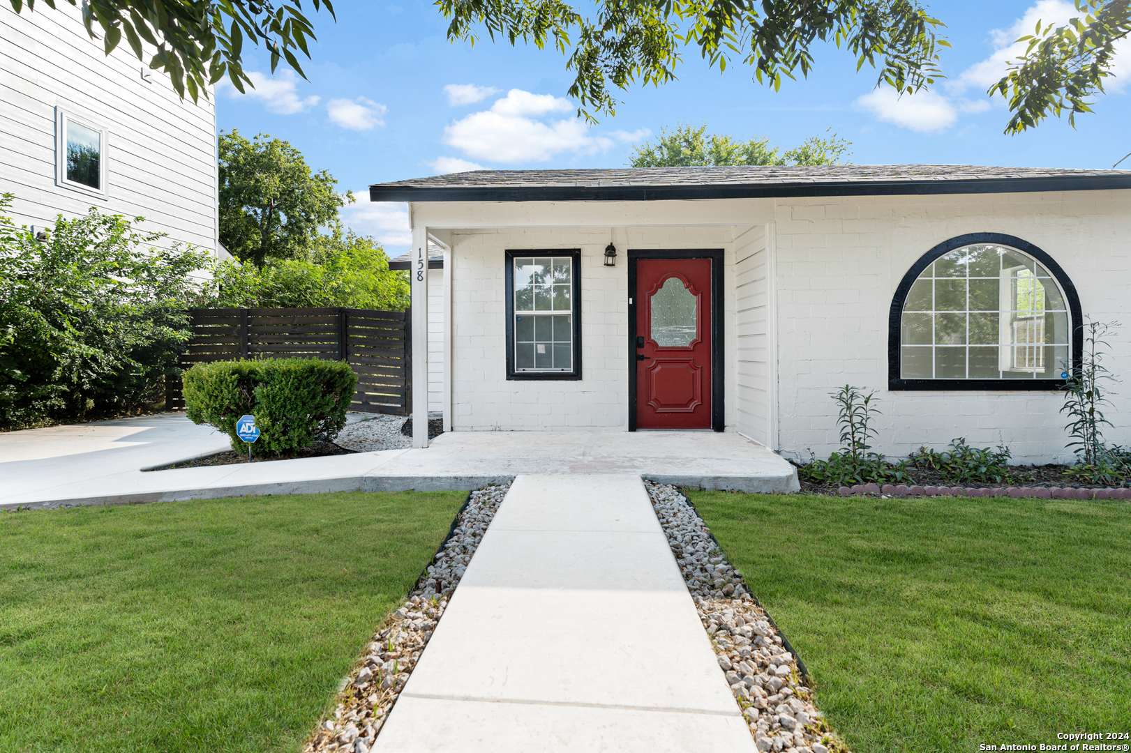 a front view of a house with garden