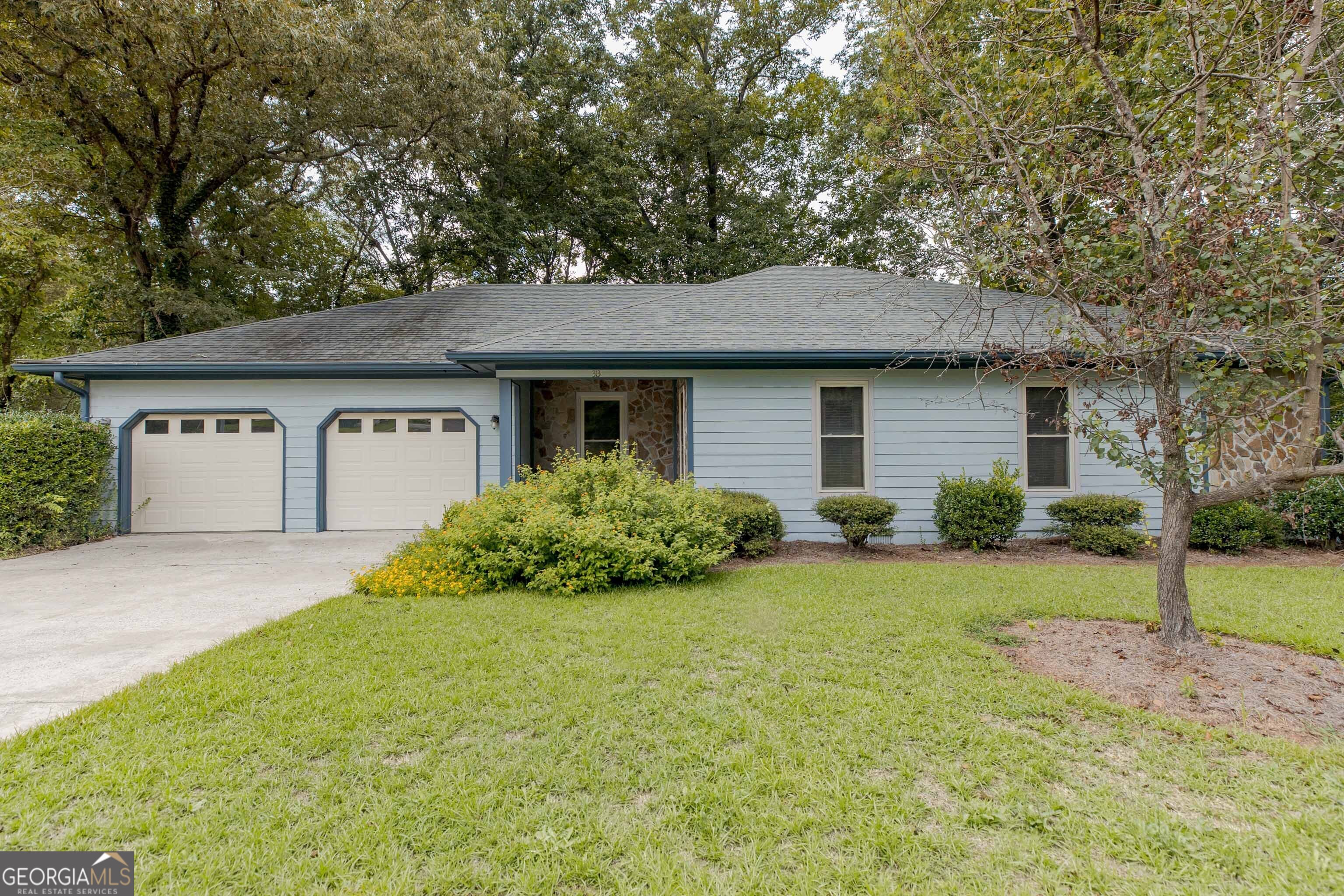 a front view of a house with garden