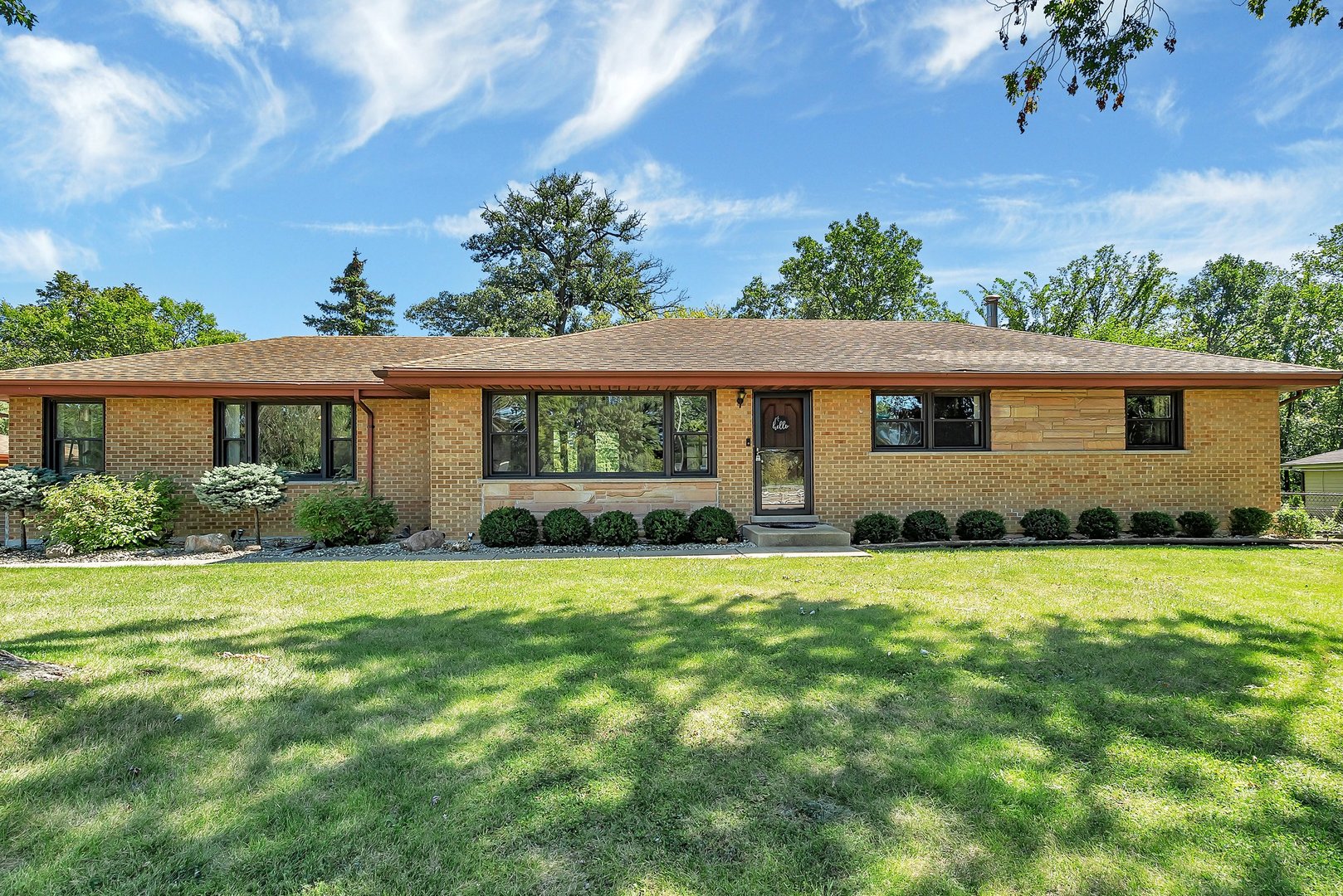 a front view of a house with a garden