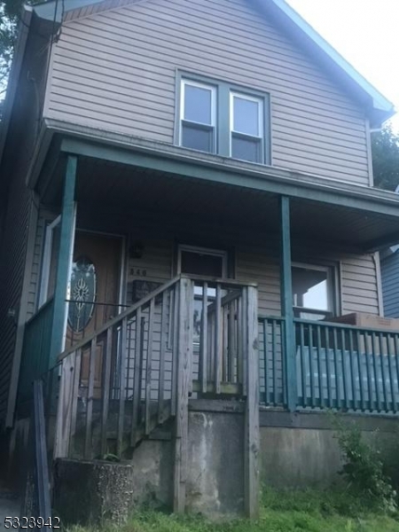 a front view of a house with wooden fence