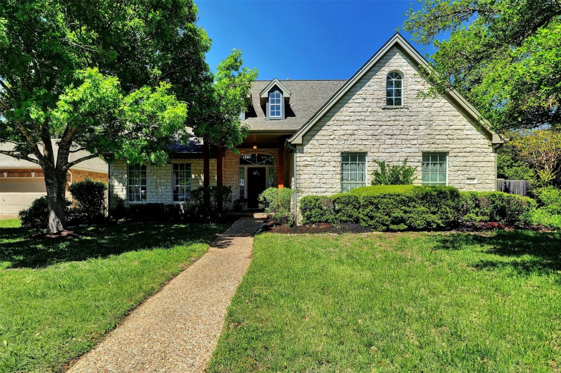 a front view of house with yard and green space