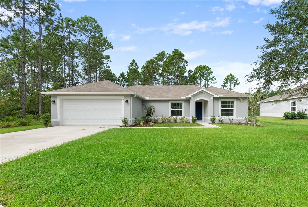 a front view of house with yard and green space