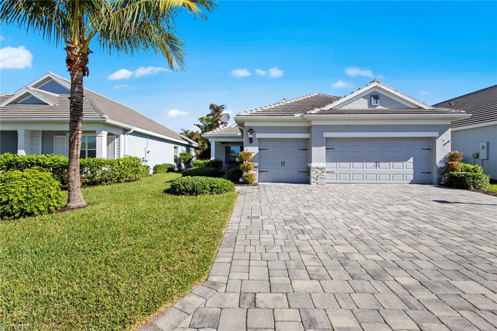 a front view of a house with a yard and garage