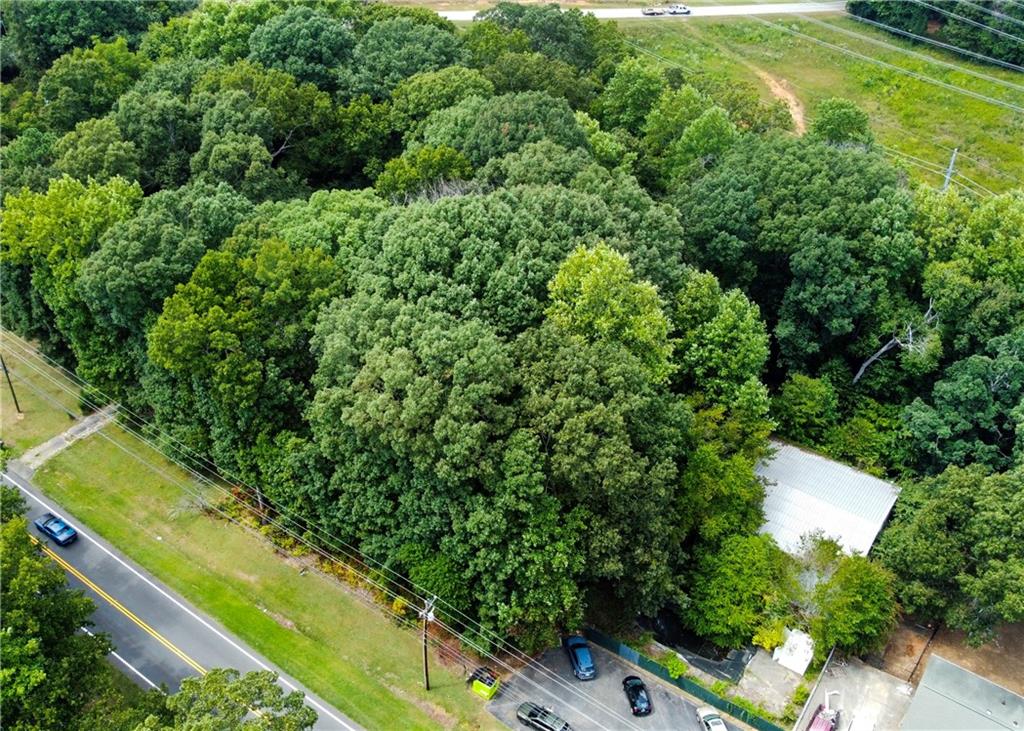 an aerial view of a residential houses with yard and swimming pool