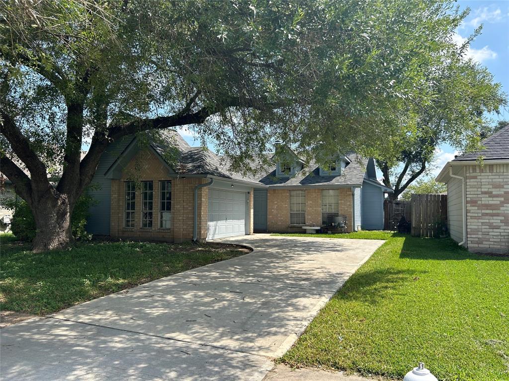 a front view of a house with a yard and trees