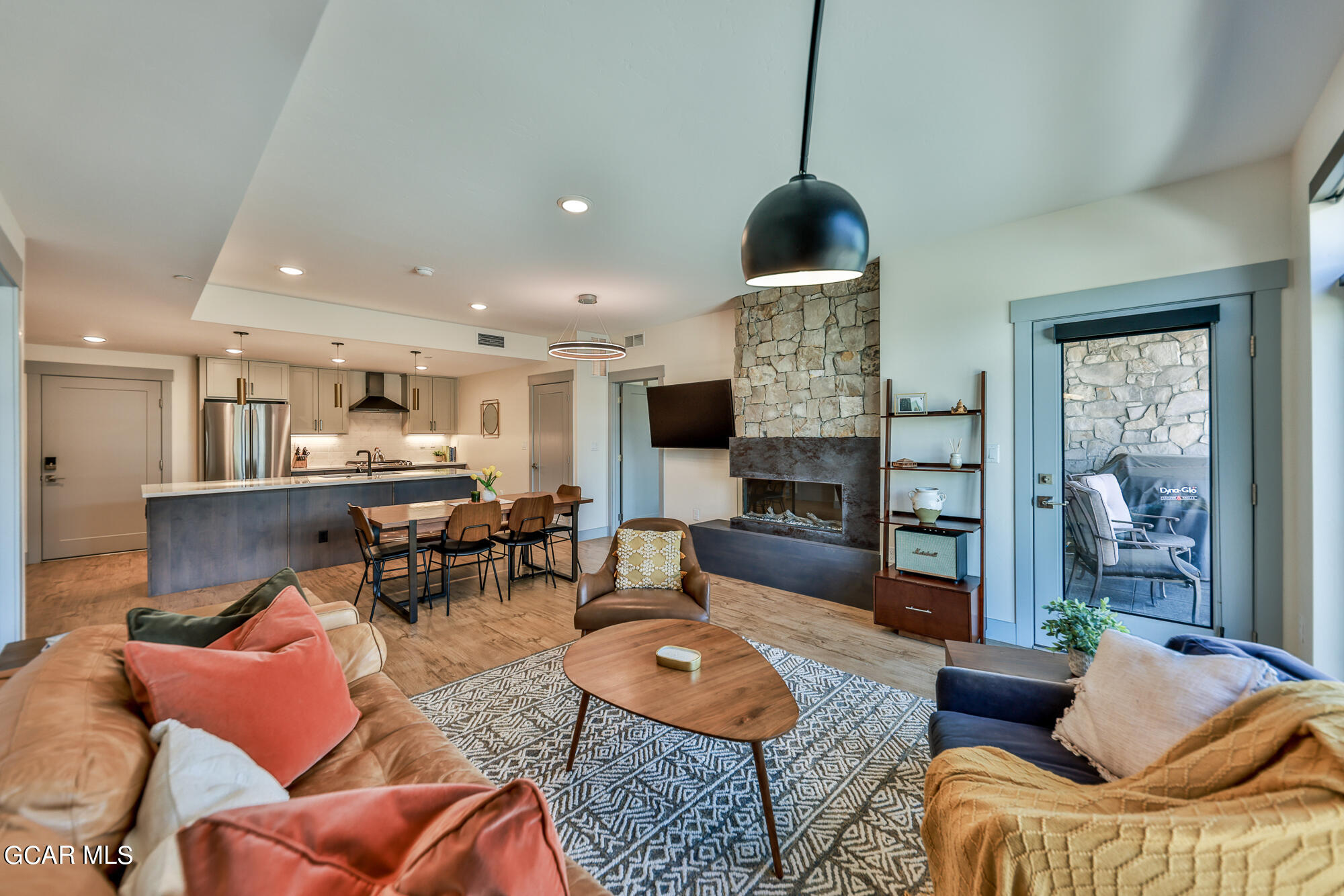 a living room with furniture and a wooden floor