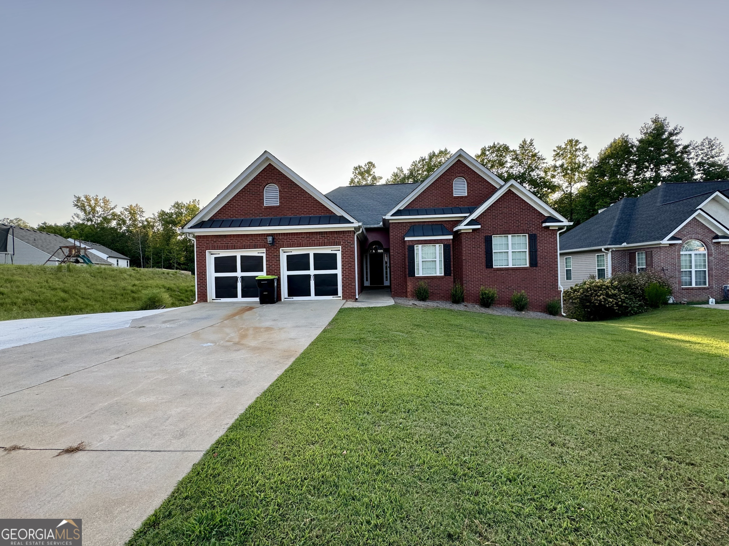 a front view of house with yard and green space