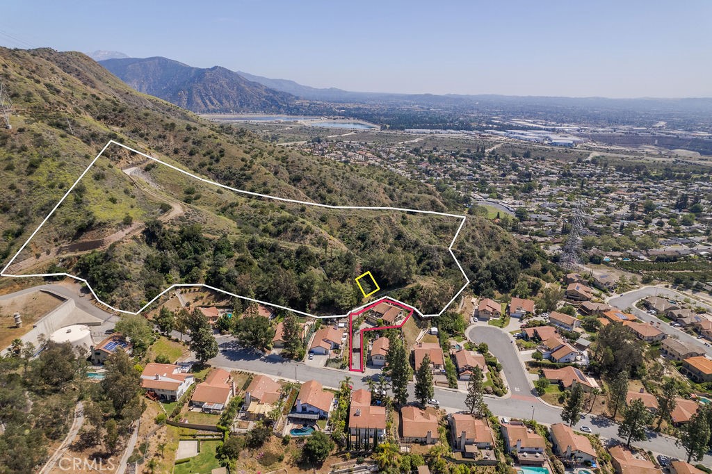 an aerial view of residential house and car parked