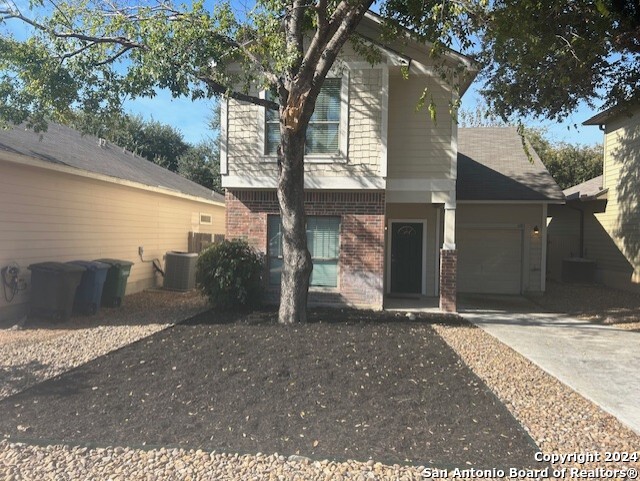 a view of a house with a tree