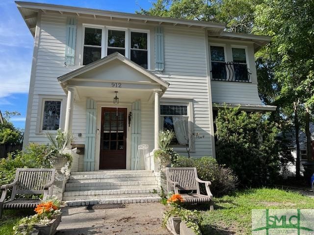 Front of house in summer - teak chairs can be remo