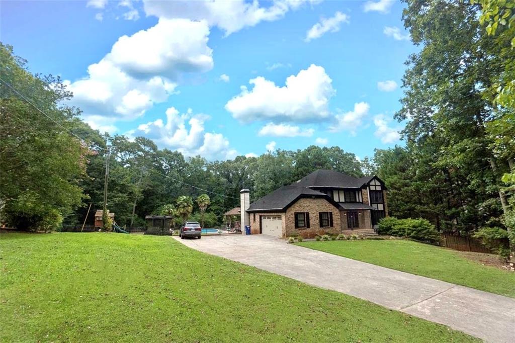 a front view of house with yard and green space