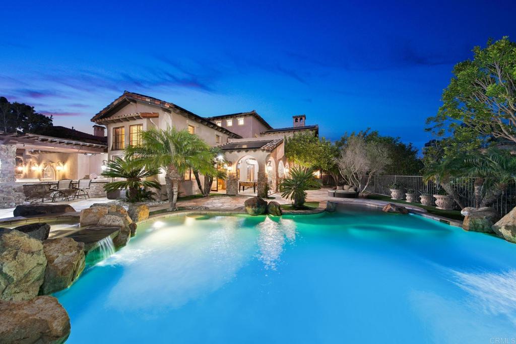 a view of a house with swimming pool and sitting area