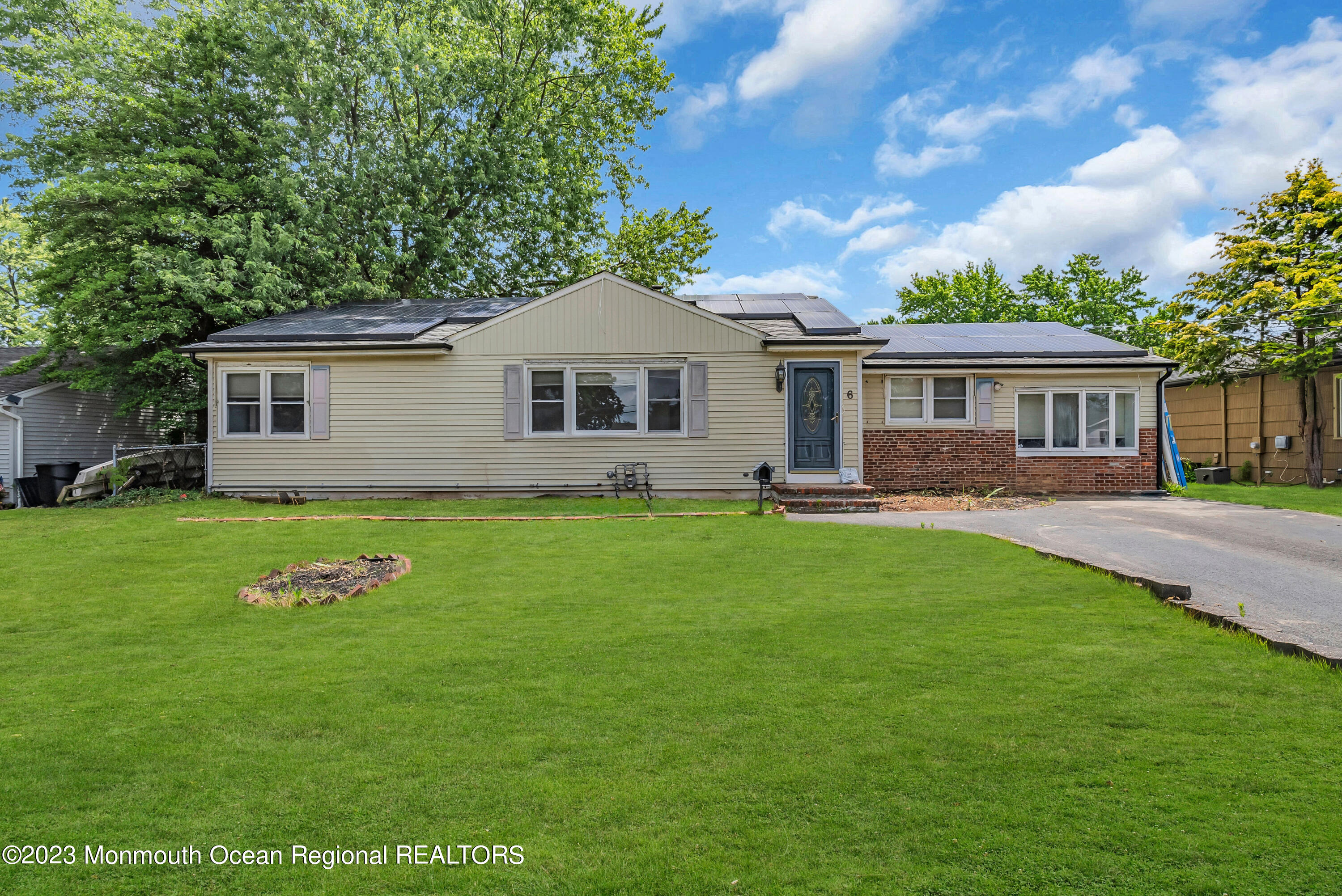 a front view of house with yard and green space