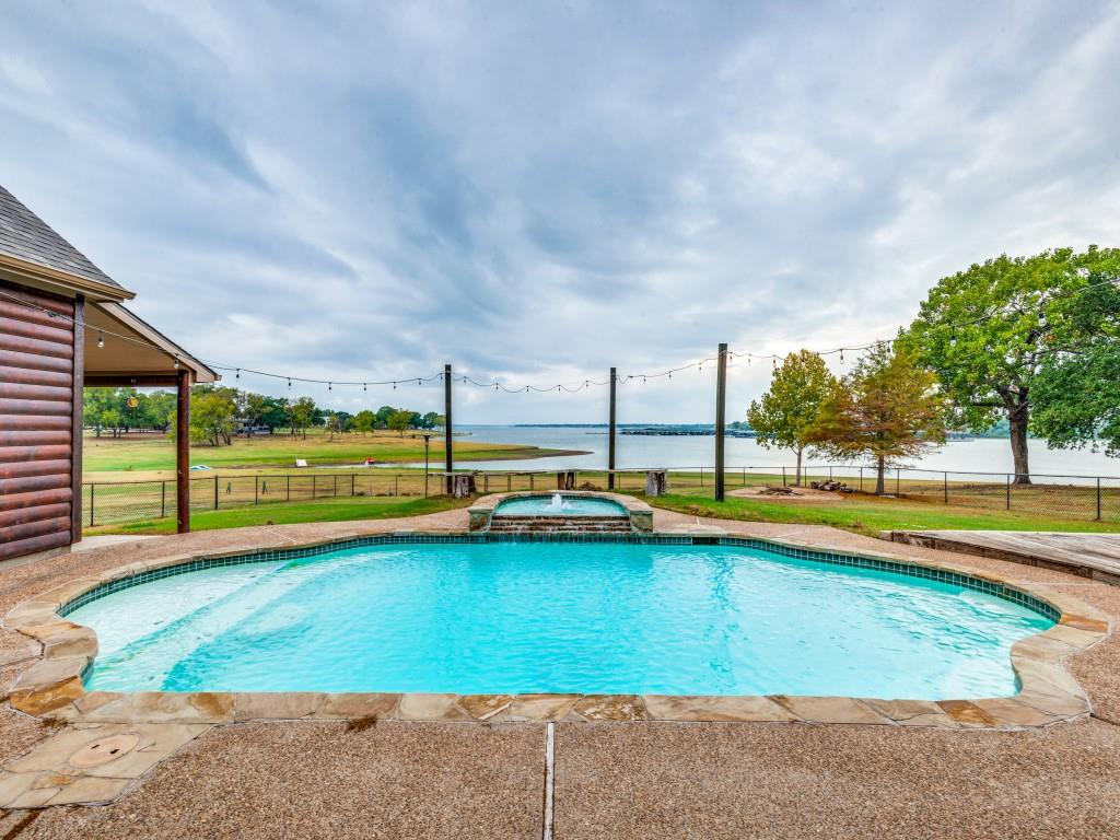 a view of swimming pool with outdoor seating and yard